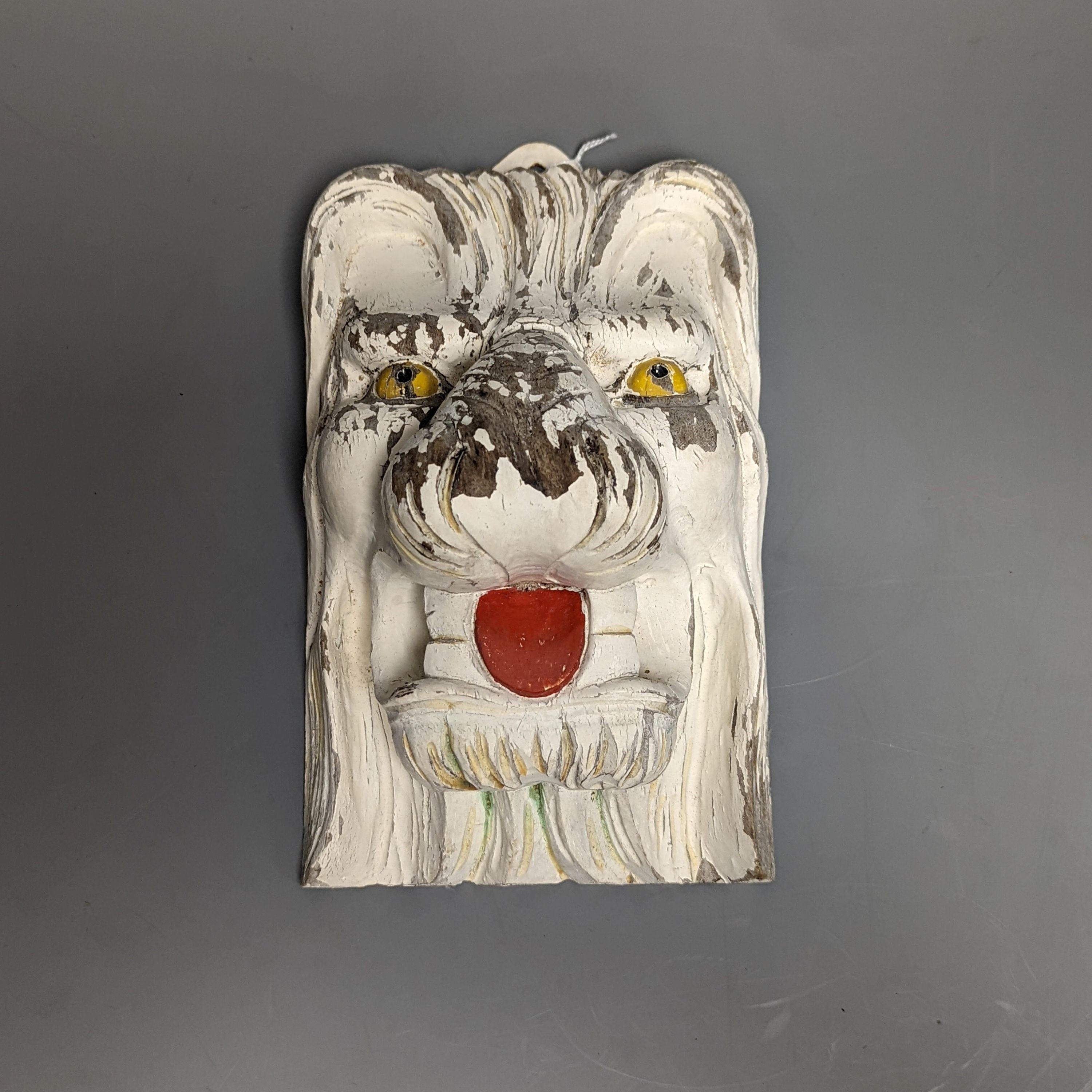 A hand carved painted wood lions head wall mount 24cm